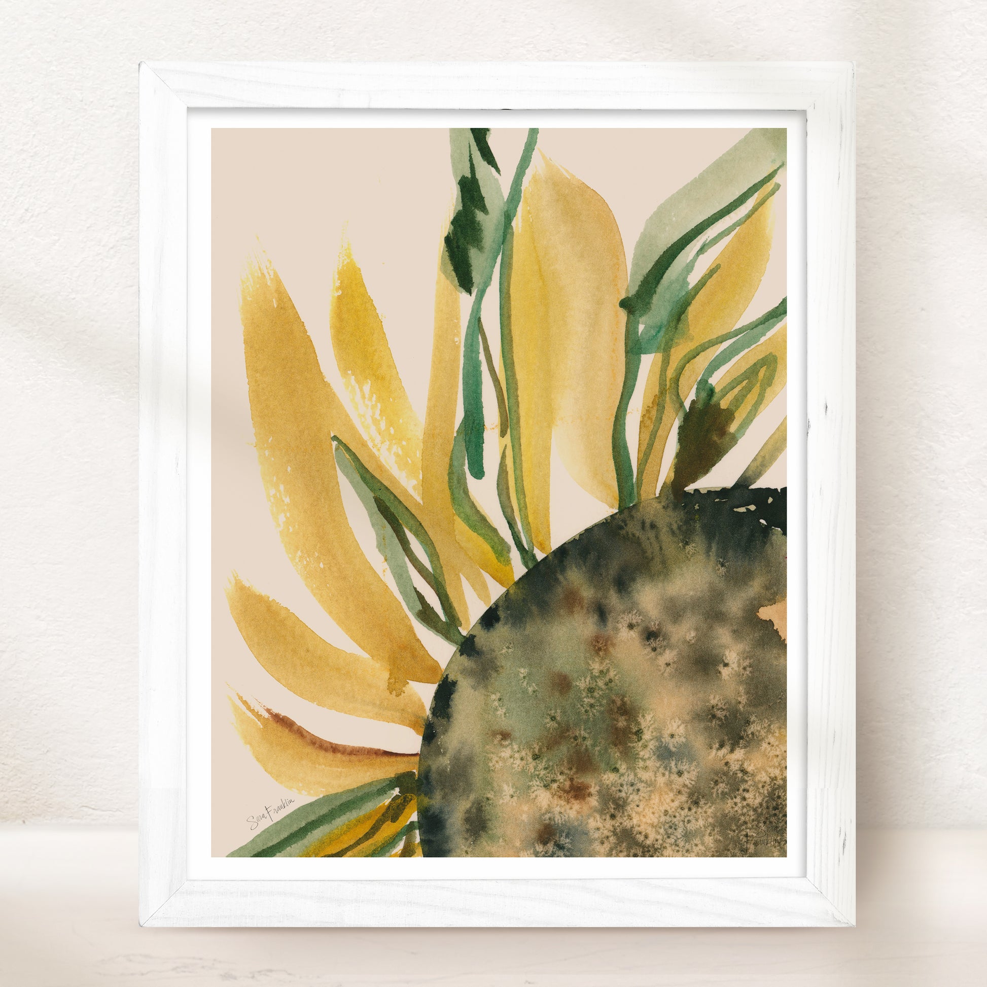 The image is a framed watercolor painting depicting a vibrant sunflower with yellow petals and green leaves.