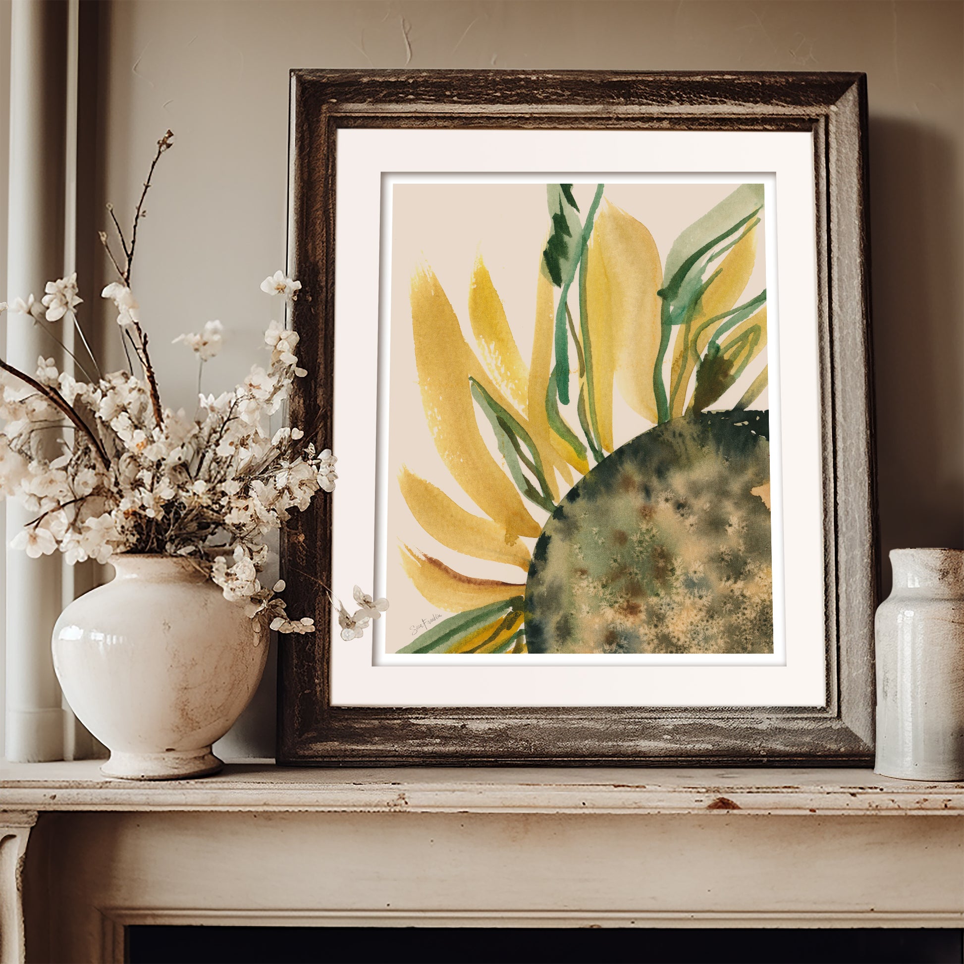 a framed painting of a yellow flower with green leaves, placed on a shelf next to a white vase filled with white flowers.