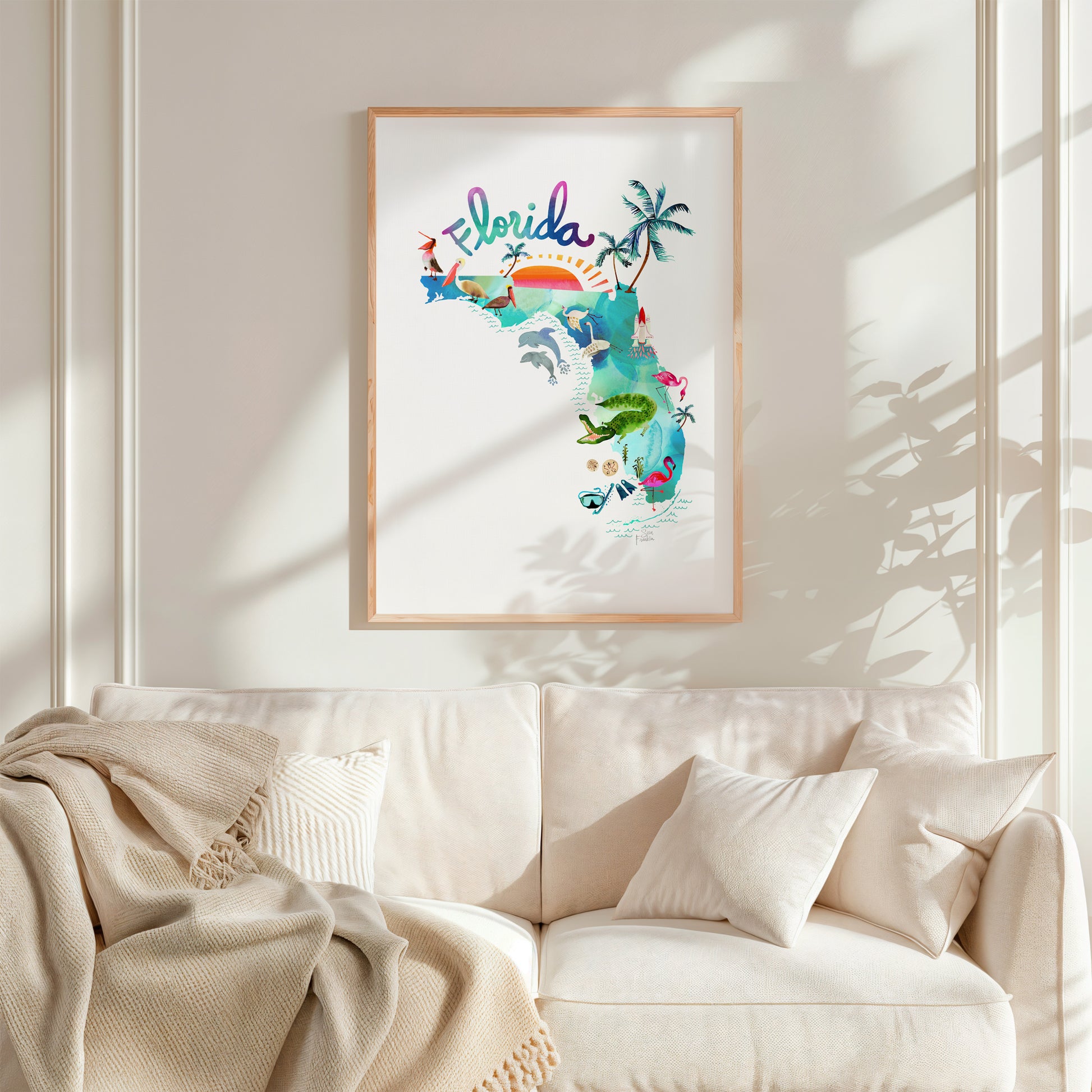 a living room with a white couch and a framed picture