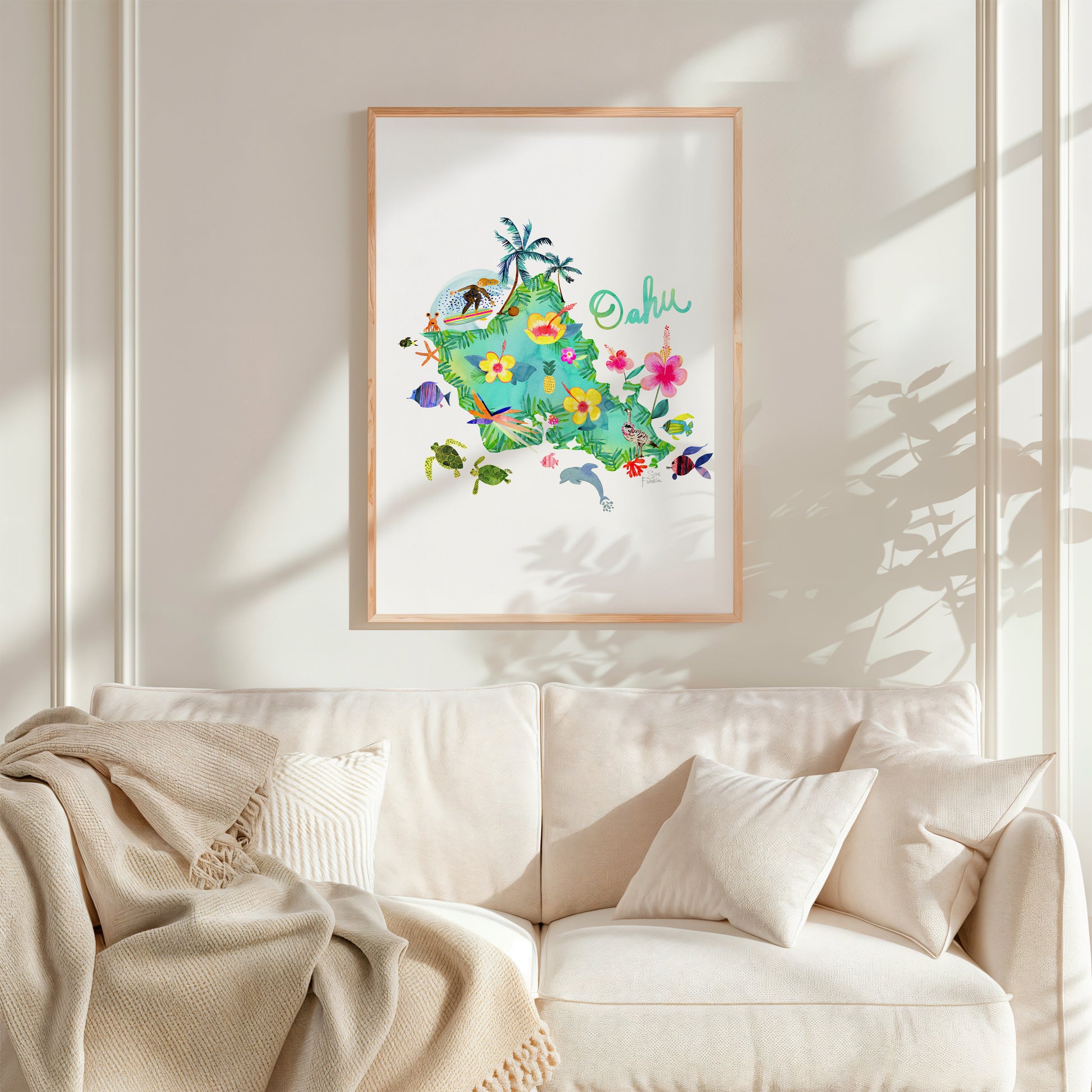 a living room with a white couch and a picture hanging on the wall
